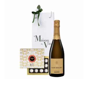 White luxury gift bag with one bottle of Mandois Blanc de Blancs Champagne and maxims de paris champagne truffle