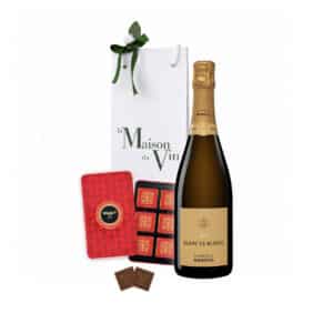 White luxury gift bag with one bottle of Mandois Blanc de Blancs Champagne and Maxim’s Milk Chocolate Squares