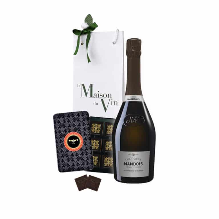 White luxury gift bag with one bottle of Mandois Cuvée Victor Blanc de Blancs Champagne and Maxim’s Dark Chocolate Squares