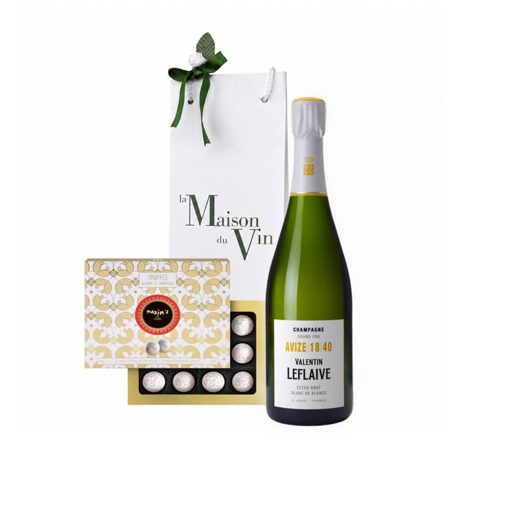 White luxury gift bag with one Avize Blanc de Blancs Champagne bottle and Maxim’s Champagne Truffles