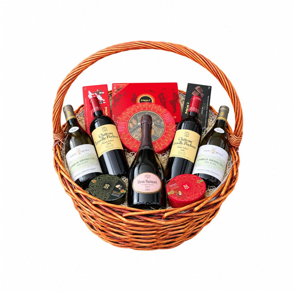 Luxury wicker basket with Dom Ruinart Rosé 2009, two Chablis Les Clos bottles, two Léoville Poyferré bottles and Maxim’s chocolates
