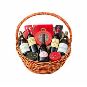Luxury wicker basket with Dom Ruinart Rosé 2009, two Chablis Les Clos bottles, two Léoville Poyferré bottles and Maxim’s chocolates